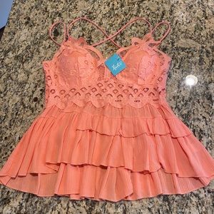NWT Coral tank top with lace detail. Crisscross straps on the back.